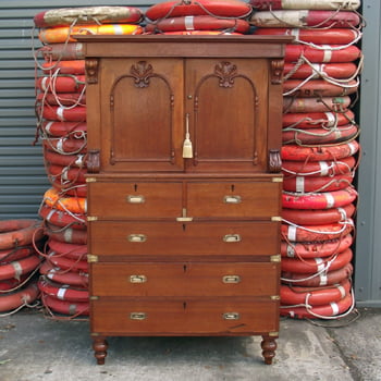 A Campaign Chest of Drawers with Dresser Top